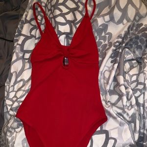 Super cute red bodysuit with a hole in the middle.
